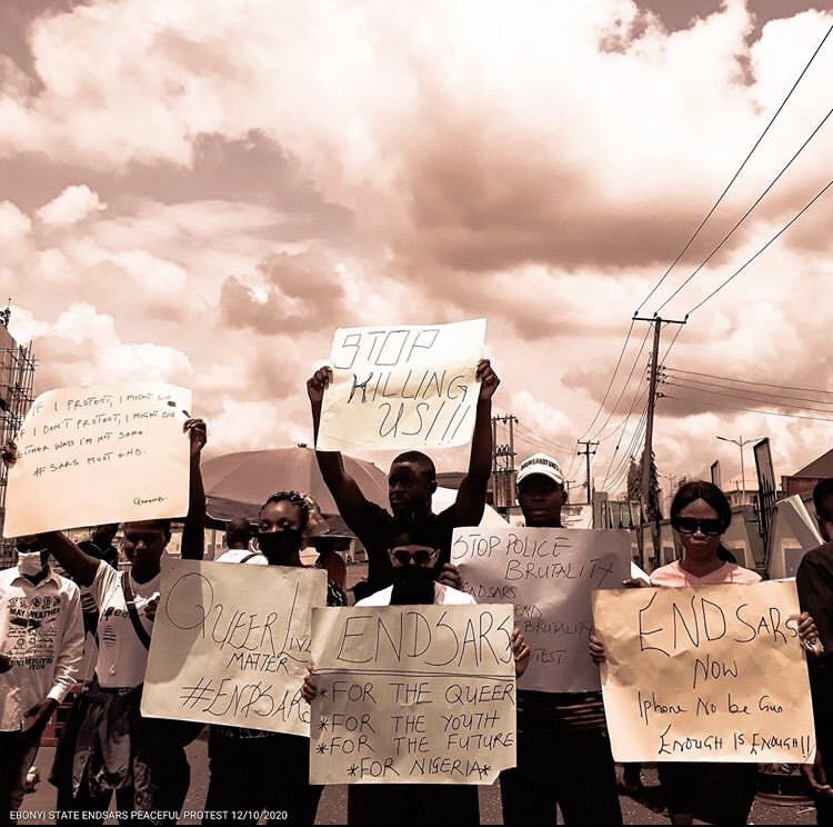 Queer Nigerians holding up placards saying, "Queer Lives Matter"